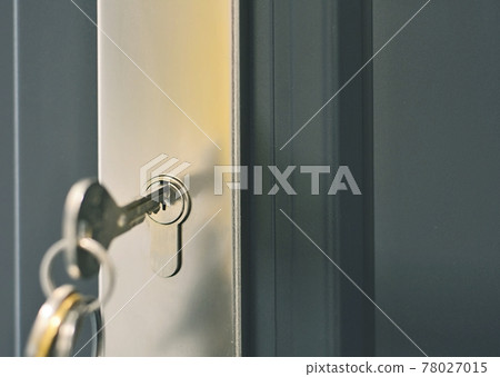 Key inserted in a door lock Key inserted in a door lock 78027015