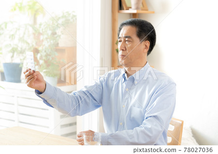 Middle-aged and older men taking medicine 78027036
