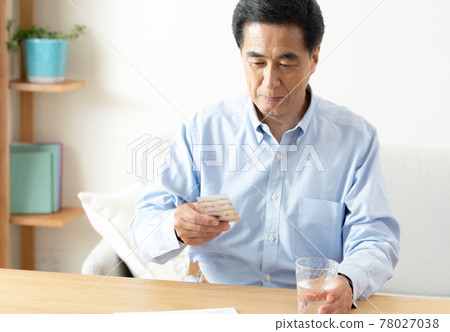 Middle-aged and older men taking medicine 78027038