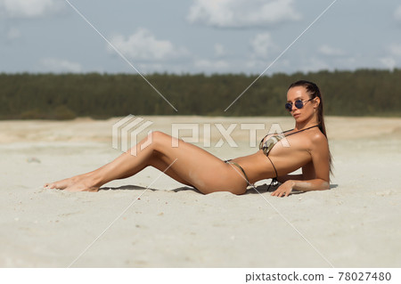 Seductive female resting on beach 78027480