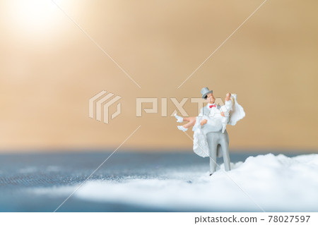 Miniature people Happy wedding couple on white beach Miniature people Happy wedding couple on white beach 78027597