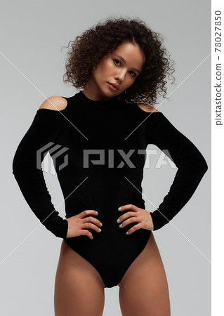 Voluptuous woman in underwear standing gracefully in studio 78027850