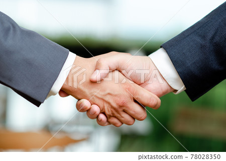Corporate Businessmen Handshake Indoors.Two People Professionally Well Dressed Gesturing Togetherness.Working Colleague Partners Sign Deal In Agreement To Contract 78028350