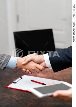 Corporate Businessmen Handshake Indoors.Two People Professionally Well Dressed Gesturing Togetherness.Working Colleague Partners Sign Deal In Agreement To Contract 78028362