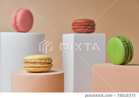 Tasty macarons on trendy geometric pedestals on a beige background 78028375