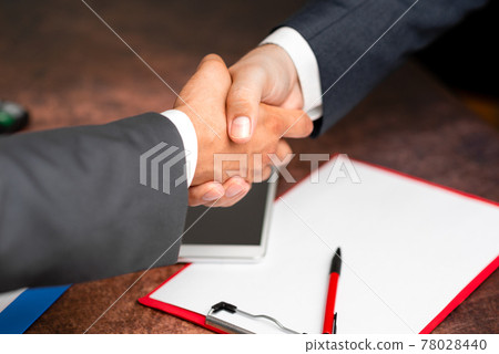 Corporate Businessmen Handshake Indoors.Two People Professionally Well Dressed Gesturing Togetherness.Working Colleague Partners Sign Deal In Agreement To Contract 78028440