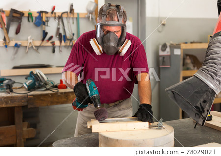 Worker in protective mask grinds wooden 3d detail Worker in protective mask grinds wooden 3d detail 78029021