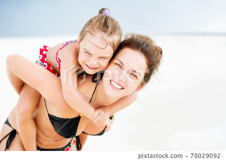 Happy mother and daughter on the ocean beach on Maldives at summer vacation 78029092