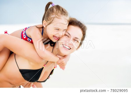 Happy mother and daughter on the ocean beach on Maldives at summer vacation 78029095