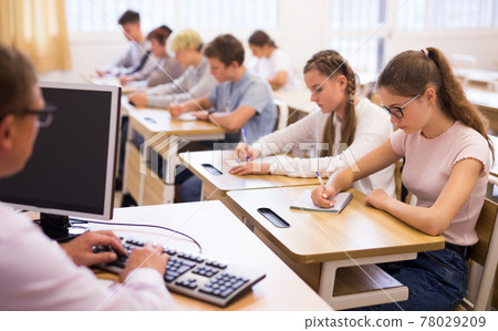 Teenage students working at class during lesson 78029209