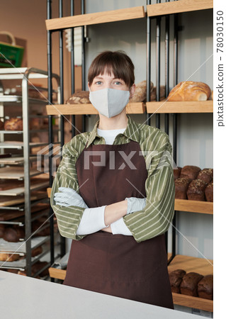 Woman in mask in bakery shop 78030150