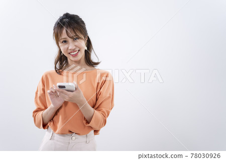 Woman using a smartphone Woman using a smartphone 78030926