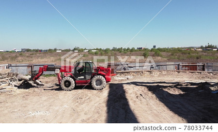 The loader loads the stone. Front Loader on Construction Site. Bulldozer works on construction site. Excavator on a construction site, people work on a construction site. 78033744