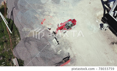 Top view of reinforced concrete structure and wheel loader. Front Loader on Construction Site, preparing to change the nozzle for work. Bulldozer works on construction site, aerial or top view. Top view of reinforced concrete structure and wheel loader. Front Loader on Construction Site, preparing to change the nozzle for work. Bulldozer works on construction site, aerial or top view. 78033759