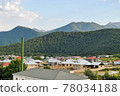 Houses at the foot of Caucasus Mountain range with peak snow background in Gebele, Gabala Azerbaijan  78034188