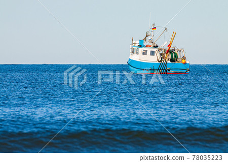 Fishing boat on the Baltic Sea in Warnemuende, Germany Fishing boat on the Baltic Sea in Warnemuende, Germany 78035223