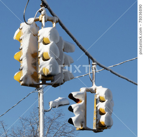 Traffic lights covered in snow after a snowstorm Traffic lights covered in snow after a snowstorm 78036890
