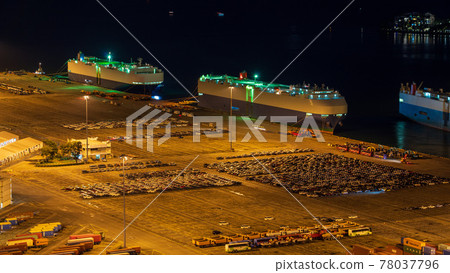 [Logistics] A car carrier anchored at a container terminal at night 78037796