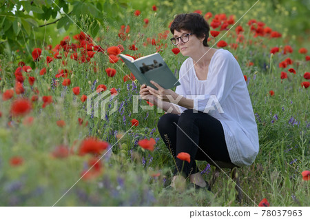 Woman In A Poppy Field Reading A Book Woman In A Poppy Field Reading A Book 78037963