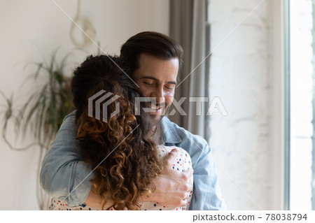 Happy sincere young man cuddling beloved woman. Happy sincere young man cuddling beloved woman. 78038794
