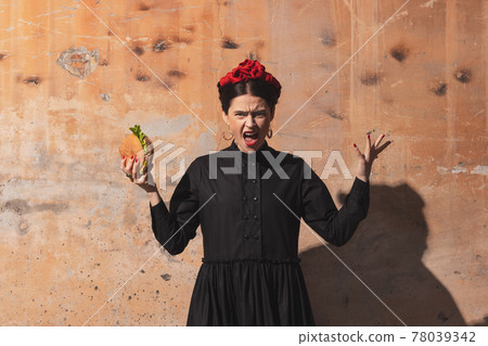 Portrait of young woman in the image of a famous artist, personality on vintage background. Retro style, comparison of eras concept. Portrait of young woman in the image of a famous artist, personality on vintage background. Retro style, comparison of eras concept. 78039342