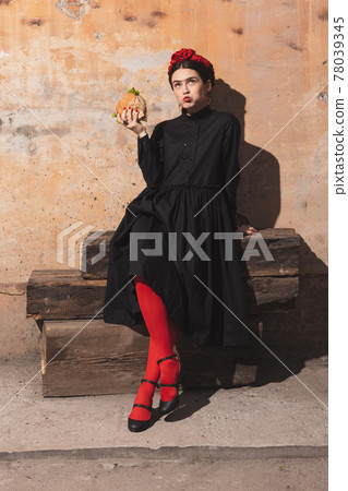 Portrait of young woman in the image of a famous artist, personality on vintage background. Retro style, comparison of eras concept. Portrait of young woman in the image of a famous artist, personality on vintage background. Retro style, comparison of eras concept. 78039345