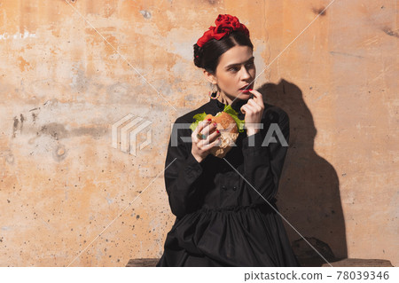 Portrait of young woman in the image of a famous artist, personality on vintage background. Retro style, comparison of eras concept. Portrait of young woman in the image of a famous artist, personality on vintage background. Retro style, comparison of eras concept. 78039346