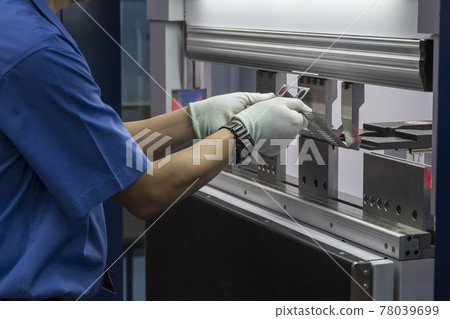 The technician operator working with hydraulic press brake bending machine. 78039699
