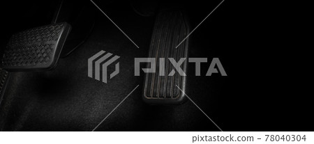 Foot pressing foot pedal of a car to drive. Accelerator and brake pedal in a car. Driver driving the car by pushing accelerator and break pedals of the car. inside vehicle. control pedal. Close up. 78040304