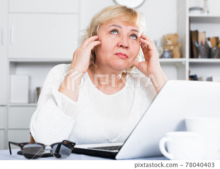 Mature woman with laptop Mature woman with laptop 78040403