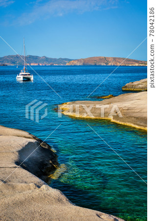 Yacht boat at Sarakiniko Beach in Aegean sea, Milos island , Greece Yacht boat at Sarakiniko Beach in Aegean sea, Milos island , Greece 78042186