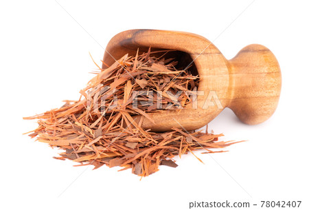 Lapacho herbal tea in wooden scoop, isolated on white background. Natural Taheeboo dry tea. Pau d'arco herb. Tabebuia heptophylla. 78042407