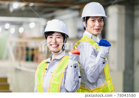 Energetic workers working at construction sites Energetic workers working at construction sites 78043580