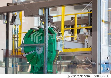 Mechanisms and details of the glass elevator at the airport. 78043631