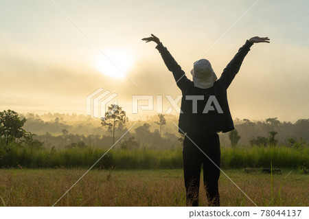 A backpacker tourist woman stretching exercise in morning, traveling at savannah mountain with fog mist at Thung Salaeng Luang National Park, Thailand. Nature landscape. People lifestyle. Relax A backpacker tourist woman stretching exercise in morning, traveling at savannah mountain with fog mist at Thung Salaeng Luang National Park, Thailand. Nature landscape. People lifestyle. Relax 78044137