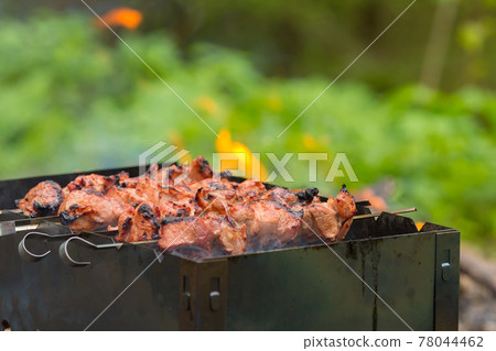 Pork kebab is cooked on skewers. Summer, picnic. 78044462