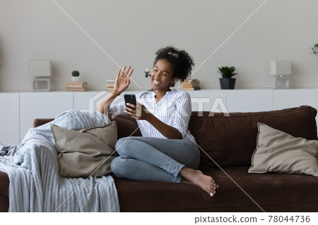 Happy millennial african woman holding web camera mobile video call. 78044736