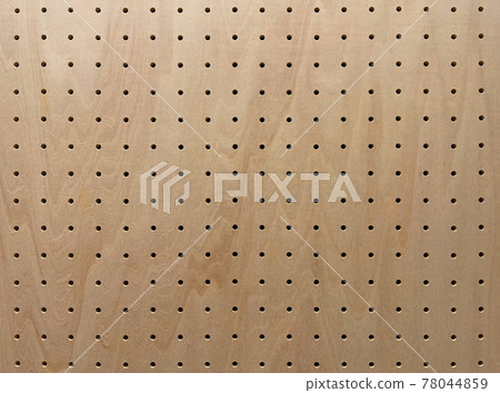 Background image of a light brown perforated board with wood grain Background image of a light brown perforated board with wood grain 78044859