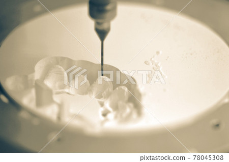 Dental milling machine carving out shape of human teeth 78045308