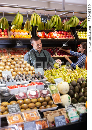 Two sellers laying out vegetables Two sellers laying out vegetables 78046329