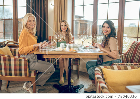 Group of women celebratining birthday and looking joyful 78046330