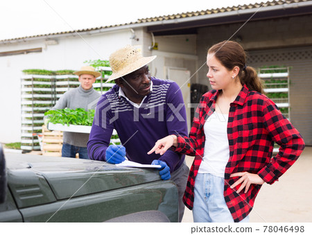 Young girl farmer buying trays with seedlings Young girl farmer buying trays with seedlings 78046498