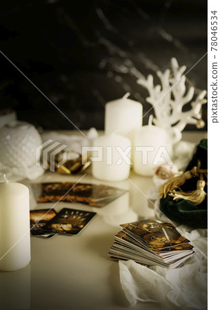 Defocused mystic ritual with tarot cards, fortune telling and esoteric symbols.  78046534