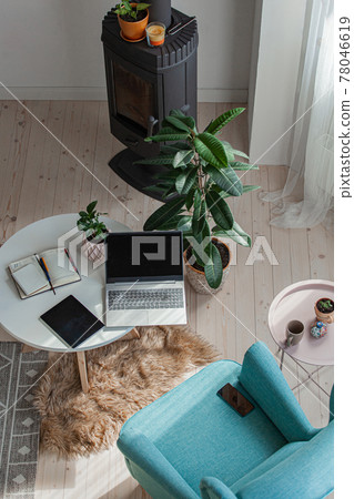 Home workplace by the fireplace, armchair, laptop, tablet to desk, top view Home workplace by the fireplace, armchair, laptop, tablet to desk, top view 78046619