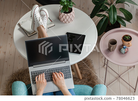Young woman using laptop screen blank, mock up, work home, top view Young woman using laptop screen blank, mock up, work home, top view 78046623