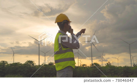Portrait of Asian windmill engineer man, worker working on site at wind turbines field or farm, renewable clean energy source. Eco technology for electric power. industry nature environment. People 78046847