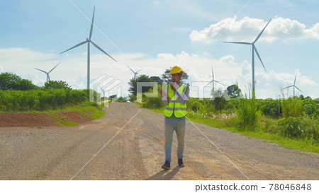 Portrait of Asian windmill engineer man, worker working on site at wind turbines field or farm, renewable clean energy source. Eco technology for electric power. industry nature environment. People 78046848