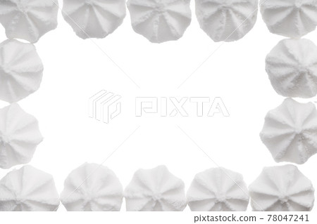 White meringue cookie isolated on white. Sweet crispy twisted cooked merengue. Copy space White meringue cookie isolated on white. Sweet crispy twisted cooked merengue. Copy space 78047241