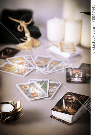 Defocused mystic ritual with tarot cards, fortune telling and esoteric symbols. Defocused mystic ritual with tarot cards, fortune telling and esoteric symbols. 78047446