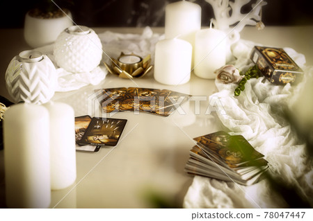 Defocused mystic ritual with tarot cards, fortune telling and esoteric symbols.  78047447